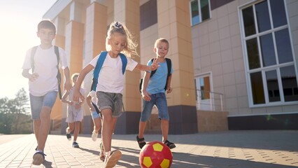 children near the school playing soccer. kids a school education kid dream concept. a group of children near the school playing ball. a lifestyle group of school children playing