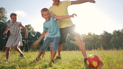 happy family playing ball in the park. a group of children playing ball at sunset in nature. happy family kid dream concept. children playing soccer in the park in nature lifestyle