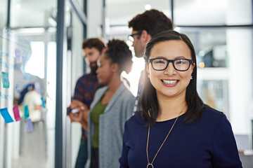 Portrait, smile and Asian woman in business office, company and coworking in creative startup...