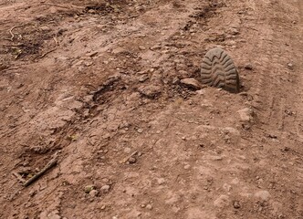 Unearthing the Past. Military Boot Buried in Time . Exploring War History and Archaeology. Foot print shoe.  Sand ground.