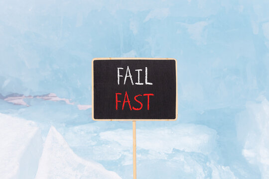 Fail fast symbol. Concept words Fail fast on beautiful yellow black blackboard. Beautiful blue ice background. Business and fail fast concept. Copy space.