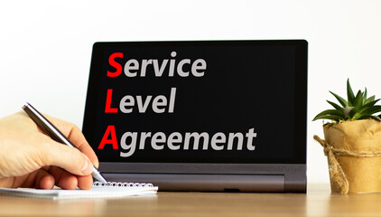 SLA service level agreement symbol. Concept words SLA service level agreement on beautiful black tablet. Beautiful white background. Business SLA service level agreement concept. Copy space.