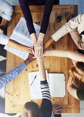 Creative people, hands together and teamwork with documents above for collaboration, support or...