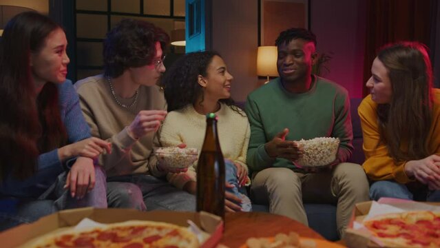 People having conversation and sharing evening with pizza