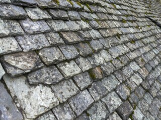 Old broken stone roof tiles, slate grey