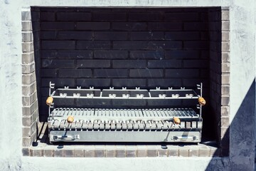 Traditional Outdoor Brick Barbecue Grill Under Sunlight Awaiting Use