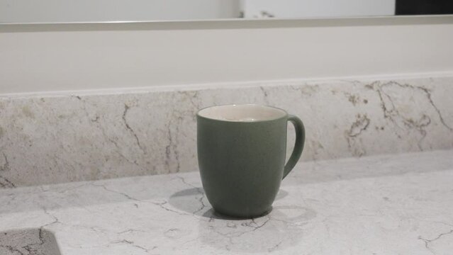 Pushing in toward the mug on a counter.