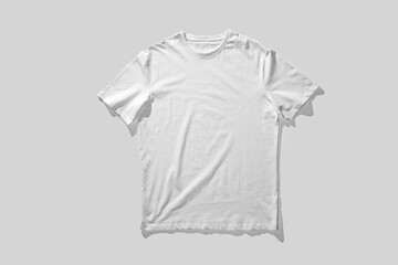 A clean, white t-shirt is displayed flat on a neutral gray surface for visual merchandising.