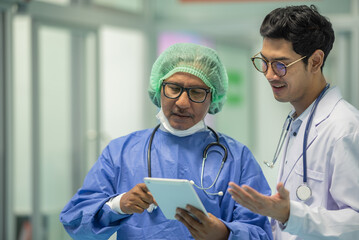 Two senior doctor hold clipboard document file of patient record talking discussion about treatment...