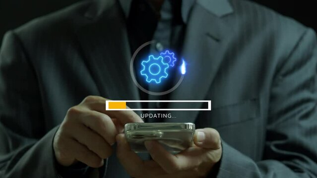 Software update or operating system upgrade concept. Installing update process, Improved functionality in the new version. Businessman using smartphone to show animation of cogwheels with updating bar