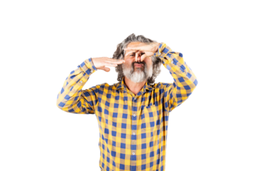 Bearded man in checkered shirt smelling something smelly and disgusting holding his breath with fingers in his nose, bad smell