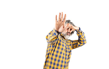 Bearded man in checkered shirt smelling something smelly and disgusting holding his breath with...