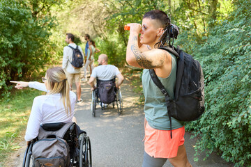Group of friends enjoying a nature walk, including people using wheelchairs and prosthetic leg