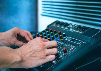 Sound engineer hands adjusting control sound mixer in recording, broadcasting studio,Sound mixer....
