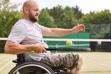 Person in wheelchair engages in tennis, showing active lifestyle and sports inclusion