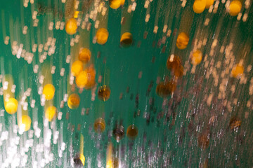 Defocused green and golden holiday bokeh. Abstract christmas background