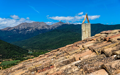 A chimney on a traditional tiled roof at Gura village in the Feneos valley, a region in Greece in the Peloponnese. Known for its natural beauty, including picturesque lakes and mountainous landscapes. - 786221532