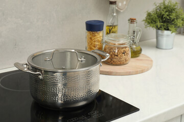 Cooking dinner. Pot on cooktop in kitchen