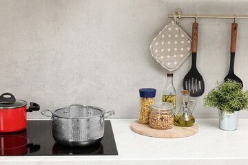 Cooking dinner. Pot on cooktop in kitchen