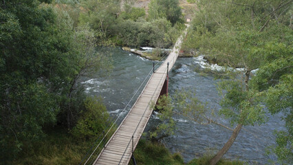 Alejico suspension bridge over the Esla river from drone