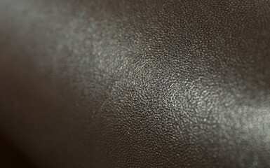 Dark brown natural leather as background, closeup view