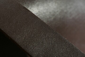 Dark brown leather as background, closeup view
