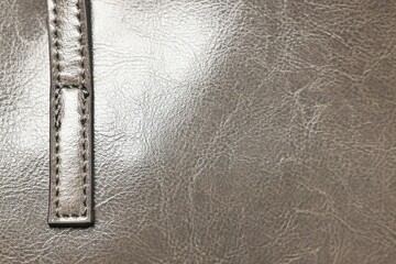 Natural leather with seams as background, top view