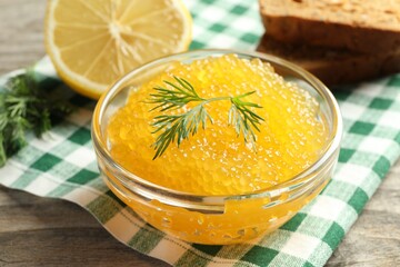 Fresh pike caviar in bowl on wooden table, closeup