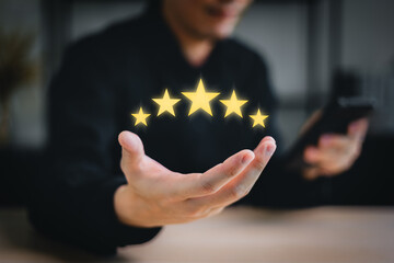hand of customer or client holding the stars to complete five stars. with copy space. giving a five star rating. Service rating, satisfaction concept. - obrazy, fototapety, plakaty