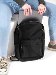 Girl with black backpack on white background