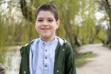 Portrait of 6 year old boy in spring park.
