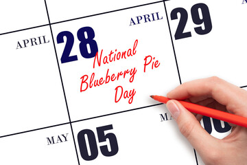 April 28. Hand writing text National Blueberry Pie Day on calendar date. Save the date.