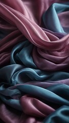 Obraz premium Elegant folds of fabric intertwine, showcasing dance between light, shadow, texture, color. Soft curves create visual symphony, where rich hues of pink, blue gracefully flow into each other.