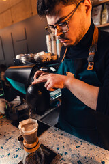 Barista preparing filter coffee in a modern coffee shop.