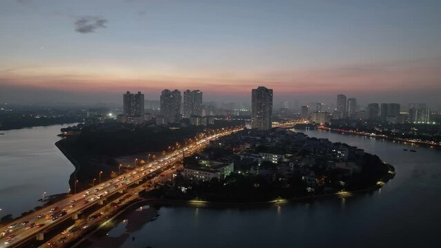 Aerial drone skyline view of Hanoi cityscape at night in Linh Dam lake