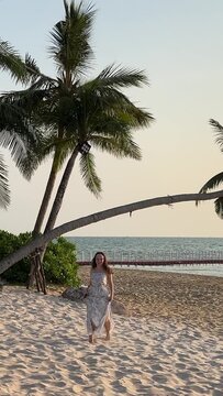 Girl walking on the beach Paradise beaches of Fukuoka Phu Quoc Sonasea beach. Palm trees sea sunset Indian Ocean Luxury vacation near hotels. Travel travel agency destination beauty of nature