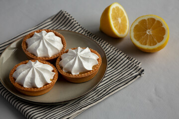 Homemade Lemon Tartlets on a Plate, side view.