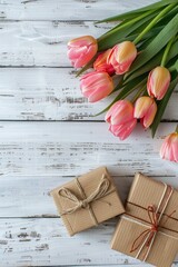 Pink tulips on a white wooden background, top view. Greeting card with tulips and gift box, space for text. Valentine's Day, Woman's Day, Mother's Day, Easter.