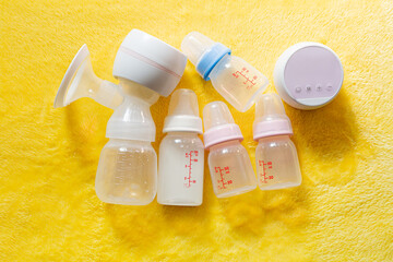 Breast pumps and bottles,Breast pump and feeding bottle for newborn baby with blanket background 