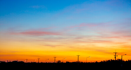 Clouds and orange sky,Real majestic sunrise sunset sky background with gentle colorful clouds without birds.Panorama, large