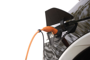 Electric car charging. Electric vehicle charging port plugging in car. Charging technology, Clean...