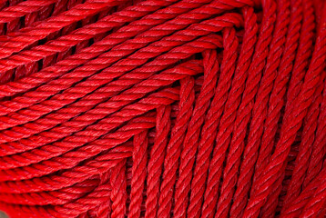 macro red rope texture,Texture of an elastic rope with a coiled hook, in red and black. Macro image. Background.