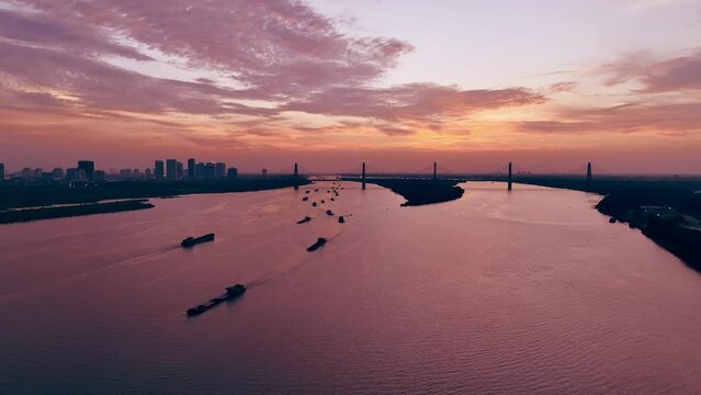 Aerial drone skyline view of Hanoi at sunset in Red River with Nhat Tan bridge