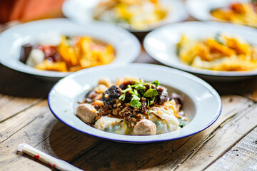 Close up plate of Pa Tor Veggie-Wrapped Rice on wooden table. Popular food of Uttaradit Province, Thailand