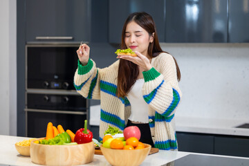 Diet lose weight and foods concept - Asian young attractive woman making sandwich clean vegetables healthy food for breakfast in morning at home.  healthy food for health