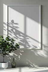 A minimalistic frame mockup on a white wall with leaf shadows creates a tranquil and artistic atmosphere.