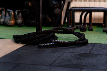 close-up in a sports club lying on the floor black ropes for strength exercises