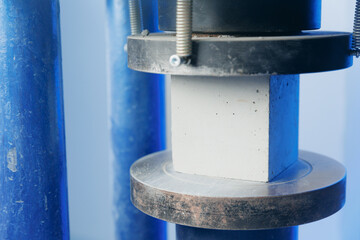 Control quality of sample concrete cube in machine press, compressive strength test. Concept...