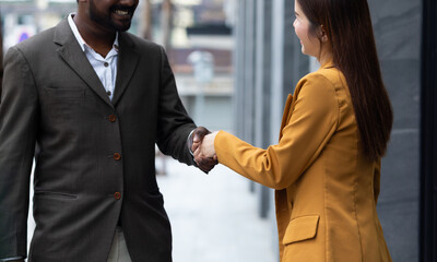 Successful business people handshake -  Asian business woman and indian business man greeting and...