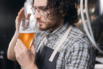 Brewer sommeliers taste quality and color of craft beer from brewery factory - obrazy, fototapety, plakaty
